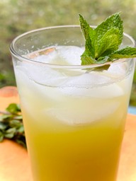 A glass of Ginger Mojito lemonade garnished with fresh mint leaves on top, showcasing a refreshing summer drink.