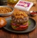 Juicy burger patty topped with caramelized onions, evoking the rich flavor boost provided by Dorot Gardens sautéed onion cubes.