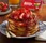 Pancakes topped with strawberries and powdered sugar.